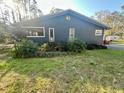 Exterior view of home with mature landscaping and screened in porch at 18840 Rustic Woods Trl, Odessa, FL 33556