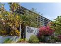 Exterior view of One Laurel Place with lush landscaping and blooming flowers surrounding the entrance sign at 201 W Laurel St # 507, Tampa, FL 33602