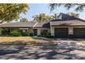 Inviting exterior showcasing the home's facade, attached garage, and well-manicured lawn at 2101 Sunset Point Rd # 1003, Clearwater, FL 33765