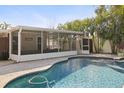 Stunning pool with sunroom, inviting for relaxation and outdoor gatherings in a tropical setting at 2460 Baywood E Dr, Dunedin, FL 34698