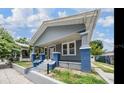 Charming craftsman-style home featuring blue and gray painted finishes, a welcoming front porch, and well-manicured landscaping at 3017 Sanchez St # 1/2, Tampa, FL 33605