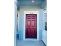 Close-up of the front door, featuring the house number 3320 and a stylish red door at 3320 Broken Bow Dr, Land O Lakes, FL 34639