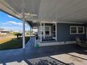 Close up of entryway area with covered parking, front porch and landscaping at 36830 Kimela Ave, Zephyrhills, FL 33542