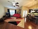 Bright living room with wood floors, vaulted ceilings, and open floor plan to the kitchen at 3917 103Rd N Ave, Clearwater, FL 33762