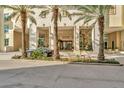 Grand building entrance with palm trees enhances the curb appeal at 450 Knights Run Ave # 1005, Tampa, FL 33602