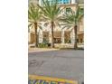 Grand building entrance with palm trees enhances the curb appeal at 450 Knights Run Ave # 1005, Tampa, FL 33602