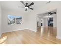 Bright living room featuring sleek hardwood floors and a connecting view to another living space at 4908 Stolls Ave, Tampa, FL 33615