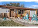 Close-up of the single-story home's front porch with decorative skeletons and colorful plants at 539 Freeport N Ave, St Petersburg, FL 33702