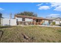 Charming single-story home with a fenced yard and unique decor on a sunny day at 539 Freeport N Ave, St Petersburg, FL 33702