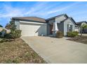 Lovely single-story home with attached two-car garage and well manicured front yard at 5446 Blue Azure Dr, Wimauma, FL 33598