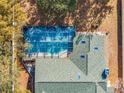 Aerial view of the screened-in pool and backyard, showcasing the outdoor living space of this home at 7948 Floral Dr, Weeki Wachee, FL 34607