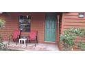 Close-up of the porch featuring chairs, a green front door, and the house number at 8006 N Temple Pl, Tampa, FL 33617