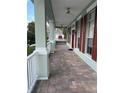 Inviting front porch featuring brick pavers and decorative columns at 8137 Cottonwood Ct, Seminole, FL 33776