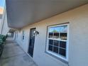 Condo exterior showing the side of the building, including a hallway and the front door at 8765 Bardmoor Blvd # 107, Seminole, FL 33777