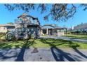 Lovely two story home featuring a balcony, manicured lawn, and a basketball hoop over the driveway at 9250 Rhea Dr, Odessa, FL 33556