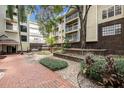 Beautiful courtyard with a waterfall feature, well-manicured plants, and brick walkways at 1000 W Horatio St # 301, Tampa, FL 33606