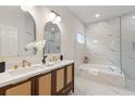 Beautiful main bathroom with double vanity, soaking tub, and marble tile at 12531 Blazing Star Dr, Tampa, FL 33626