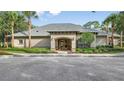 This is a beautiful community clubhouse featuring well-maintained landscaping, an inviting entrance, and ample parking for residents at 13567 Newbridge St, Spring Hill, FL 34609