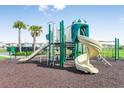 This is a colorful community playground featuring slides, climbing structures, and a soft rubber surface for safety at 13567 Newbridge St, Spring Hill, FL 34609