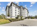 Wide angle showing the attractive building exterior, beautiful landscaping, and private entryway at 14820 Rue De Bayonne # 205, Clearwater, FL 33762