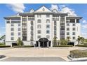 Elegant building exterior featuring multiple stories, balconies, and meticulously maintained landscaping at 14820 Rue De Bayonne # 205, Clearwater, FL 33762