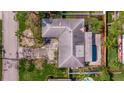 Overhead aerial view of the home showcasing the roof, backyard pool, and driveway at 2031 Tanglewood Ne Way, St Petersburg, FL 33702