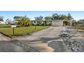 Beautiful home featuring a large driveway and well-manicured lawn, showcasing curb appeal at 3218 Fauna St, Sarasota, FL 34235