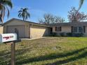 Charming single-story home featuring a well-maintained front lawn at 3320 Jackson Dr, Holiday, FL 34691