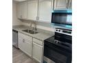 Modern kitchen features stainless steel appliances, granite countertops, and ample cabinet space at 3320 Jackson Dr, Holiday, FL 34691