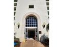 Front entrance of building featuring an arched doorway and sconce lighting at 4801 Osprey S Dr # 209, St Petersburg, FL 33711