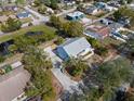 Drone shot showcasing the property, lush landscaping, and serene pond views at 6131 Central Ave, New Port Richey, FL 34653