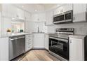 Bright, clean kitchen features stainless appliances, white subway tile backsplash, and sleek counters at 716 Cordova Grn, Seminole, FL 33777