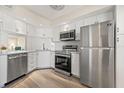Updated kitchen featuring stainless steel appliances, white cabinets, and modern countertops at 716 Cordova Grn, Seminole, FL 33777