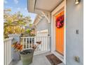 Close-up of a bright orange front door adorned with a festive wreath, creating a warm and inviting entrance to the home at 7403 S Obrien St, Tampa, FL 33616