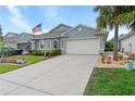 Inviting home with a well-kept lawn, lush landscaping, and a spacious driveway, perfect for a Gathering at 7497 W Lenox Cir, Punta Gorda, FL 33950