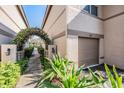 View of a townhome's garage and courtyard entrance with a trellis at 846 Normandy Trace Rd, Tampa, FL 33602