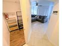 Hallway view of the closet and living space with neutral tiling and gray sofa at 8517 Sea Harbour Ln # 103, Temple Terrace, FL 33637