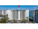 Condo with multiple stories and balconies surrounded by parking and landscaping at 9425 Blind Pass Rd # 506, St Pete Beach, FL 33706