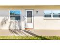 Exterior view of the front entrance with two windows on either side of the door at 952 Virginia St # 108, Dunedin, FL 34698