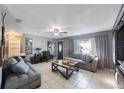 Cozy living room featuring tile flooring, neutral paint, comfortable seating, and ample natural light at 10373 54Th N Ave, St Petersburg, FL 33708