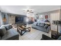 Spacious living room featuring an entertainment center, neutral paint, tile flooring, and comfortable seating at 10373 54Th N Ave, St Petersburg, FL 33708
