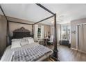 Main bedroom featuring natural light, wood flooring, a four-poster bed, and a desk at 10373 54Th N Ave, St Petersburg, FL 33708