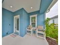 Inviting front porch with seating area, perfect for enjoying the outdoors at 11008 Sand Pine Ln, Parrish, FL 34219