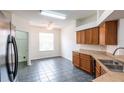 Eat-in kitchen area featuring tile flooring, stainless steel appliances, wood cabinetry, and a ceiling fan at 11116 Rodeo Ln, Riverview, FL 33579
