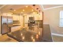 Well-lit kitchen featuring a breakfast bar with granite countertop and stainless steel appliances at 11351 130Th Ave, Largo, FL 33778