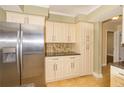 Bright kitchen with stainless steel refrigerator and a decorative backsplash at 11351 130Th Ave, Largo, FL 33778