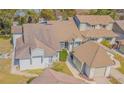 Neutral exterior showing a well-maintained home with a brown roof and attached garage at 11743 Rolling Pine Ln, Port Richey, FL 34668