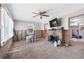 Inviting living room with stone fireplace, ceiling fan, and natural light at 120 148Th E Ave, Madeira Beach, FL 33708