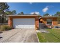 Inviting single-story home with an attached two-car garage and fenced lawn at 15429 Green Jay Rd, Weeki Wachee, FL 34614