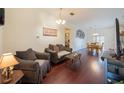 Open-concept living room with hardwood floors and cozy seating arrangement at 15429 Green Jay Rd, Weeki Wachee, FL 34614